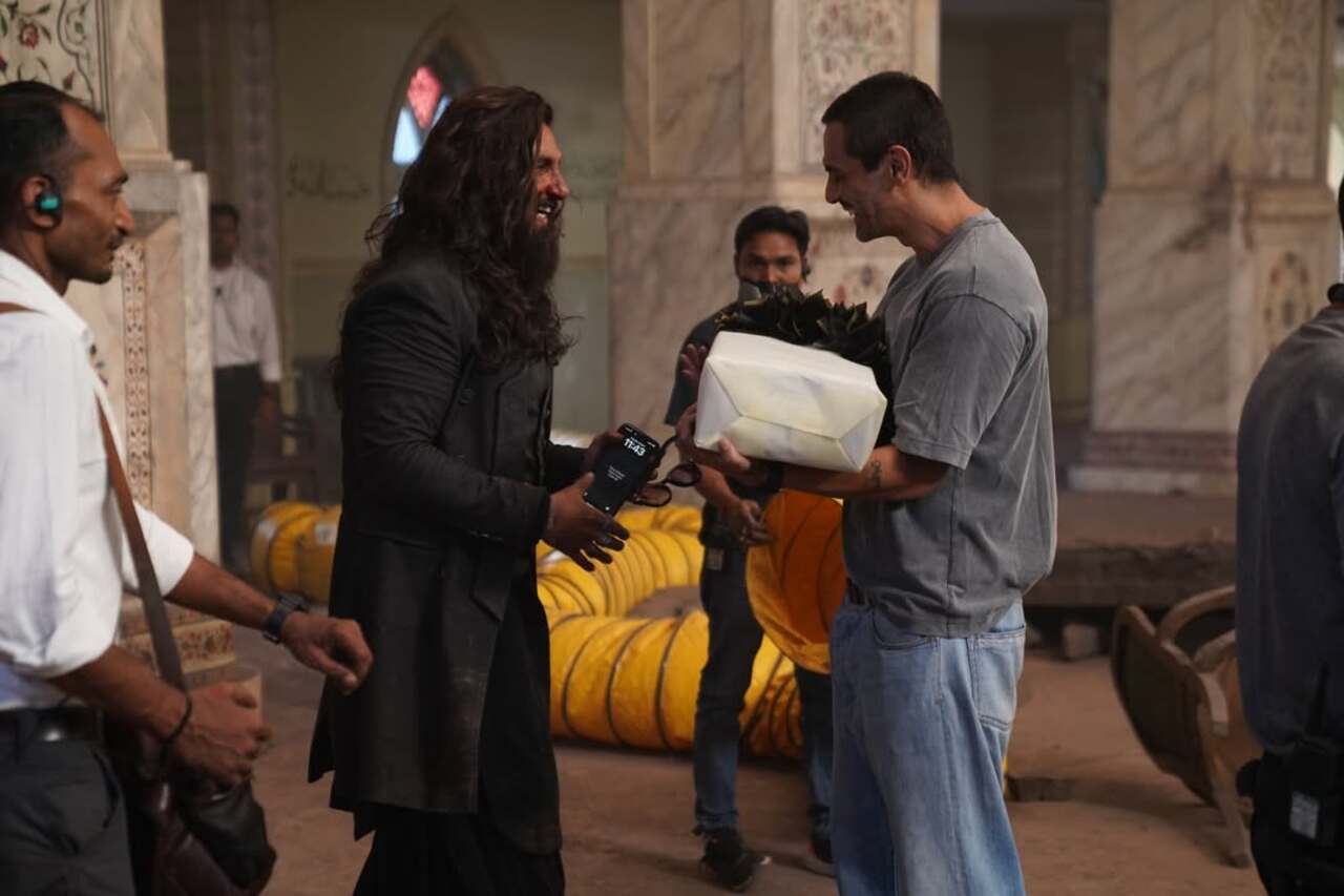Arjun Rampal surprised Ranveer Singh with a thoughtful gift on set. The duo was seen sharing a fun laugh, showcasing their easy camaraderie as compared to their on-screen dynamics.